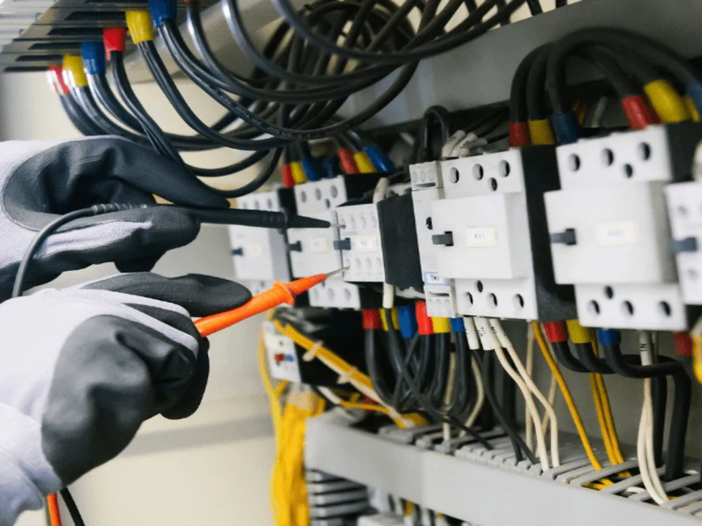 An electrician testing a panel